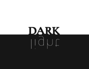 The top half of the image features a white background with the word "DARK" in a bold black. The bottom half has a black background with the word "light" in thin white lettering. The word light is upside down.